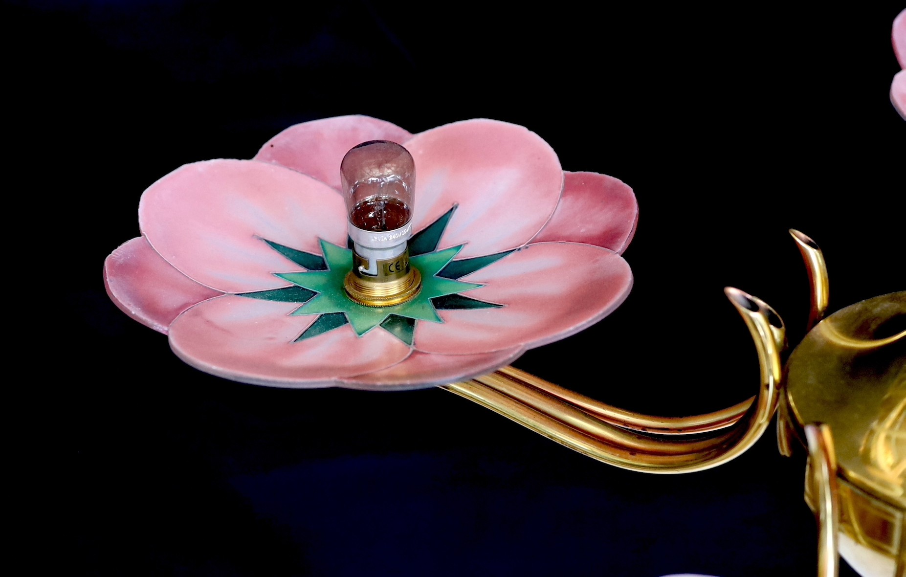 A 1930s French Leys Lurha polished brass four branch light fitting with stylised lotus flower pink glass shades, height 70cm. width 70cm